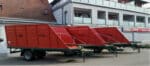 a large red trailer in a field